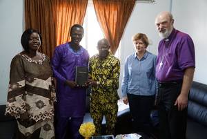 Photo 12: Hon. Ousainou Darboe receives a new Bible in his mother tongue, the Madinka Â© BQ/Martin Warnecke